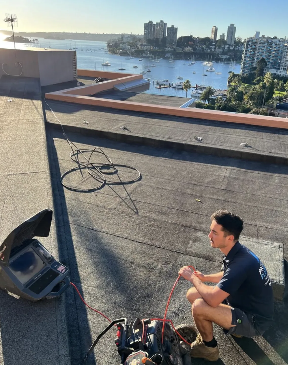 Clearing a rooftop drain on an apartment building